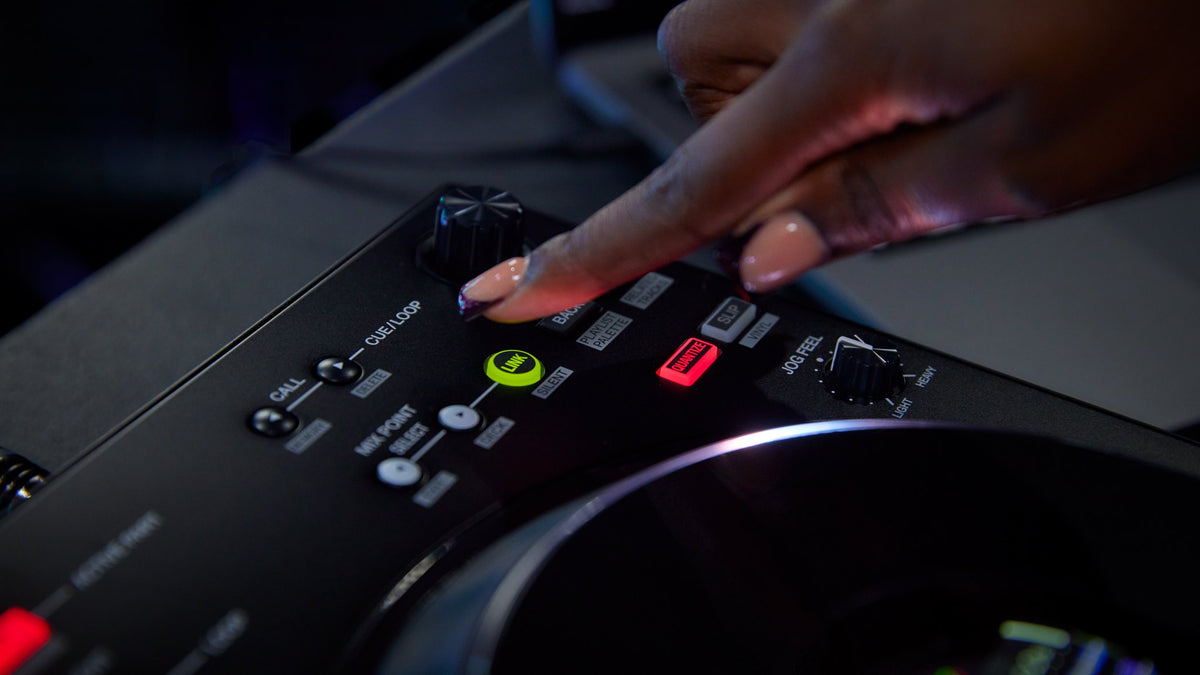 DJ's hand on the controls of a Pioneer DJ DDJ-FLX10