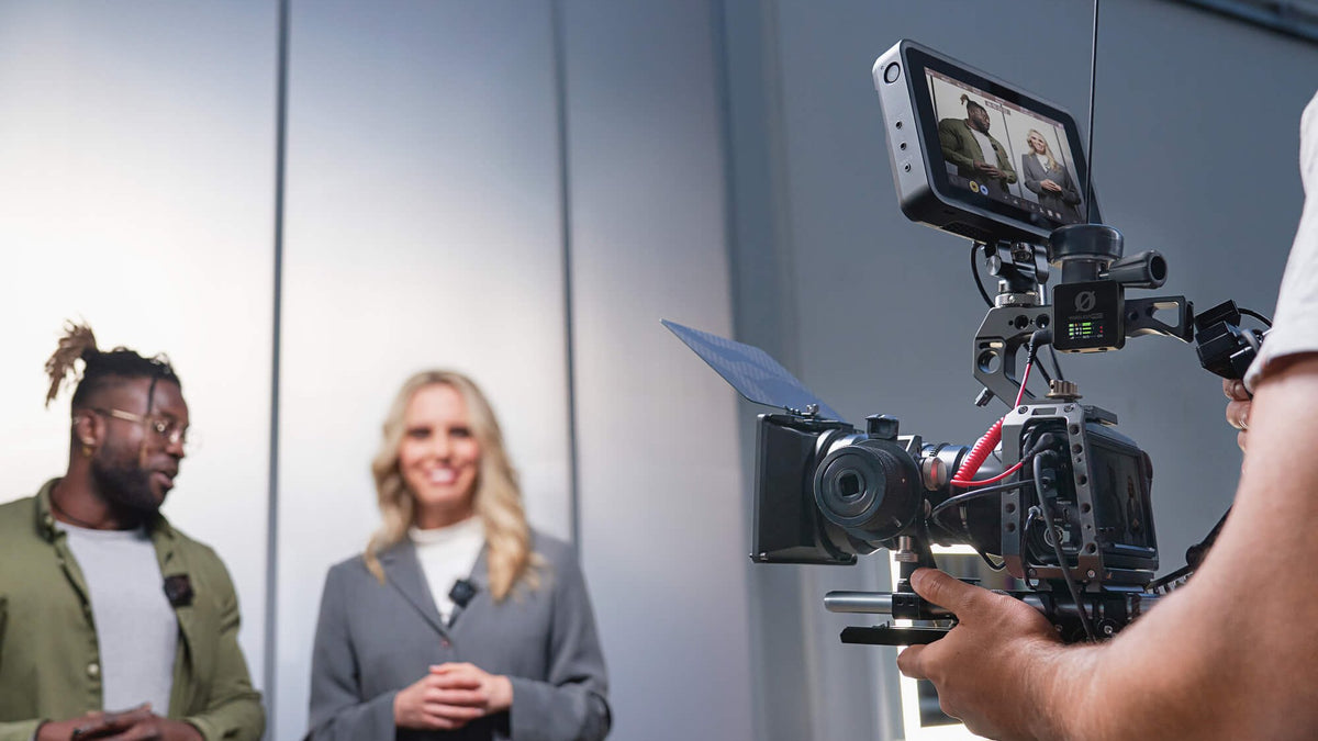 Two presenters on a studio set being filmed with RØDE Wireless PRO