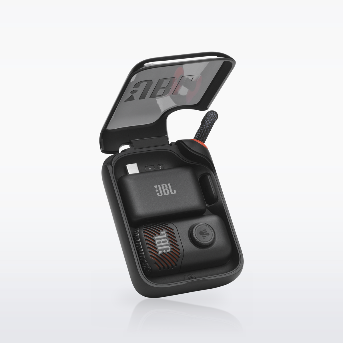 JBL EasySing Mic Mini in its open charging case with the dongle